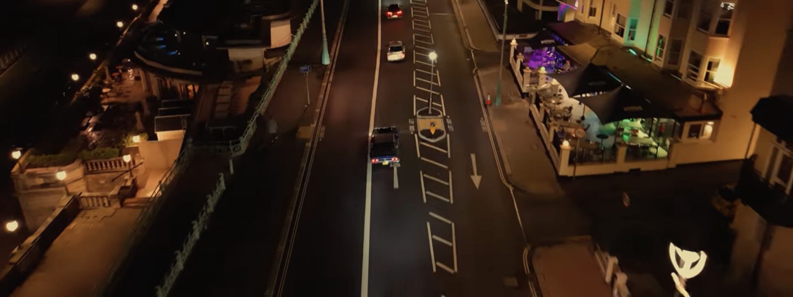 Still from Tulpa Club's Season 3 short film: a car driving through a seaside town at night